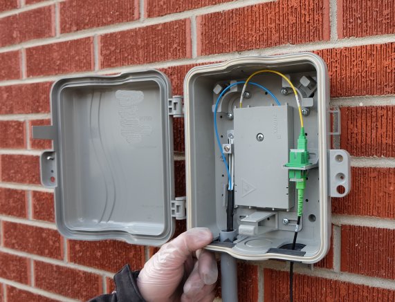 Fiber service box installed at the premise with the drop terminated and tested