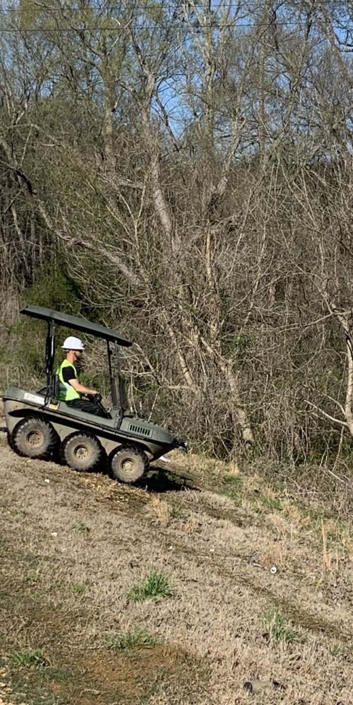 Tracked field vehicle moving through rough terrain